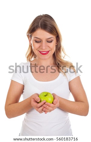 Picture of a happy young woman holding a fresh green apple