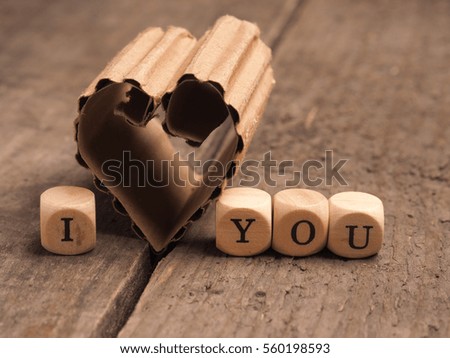 Love concept image with a cardboard heart shape using as background or greeting card