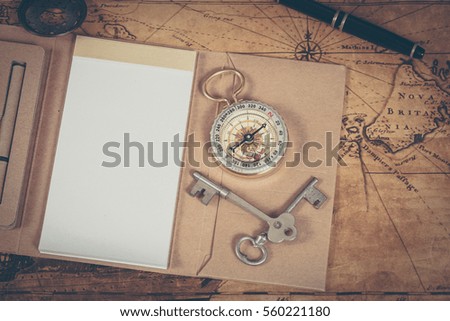 Compass with note book on old map vintage process style