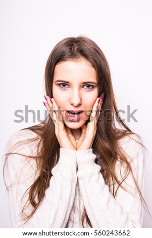 Portrait of young  exited fashion girl in white sweater on white