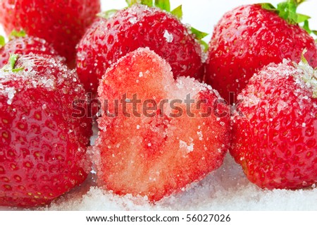strawberries and sugar on a white background. closeup.