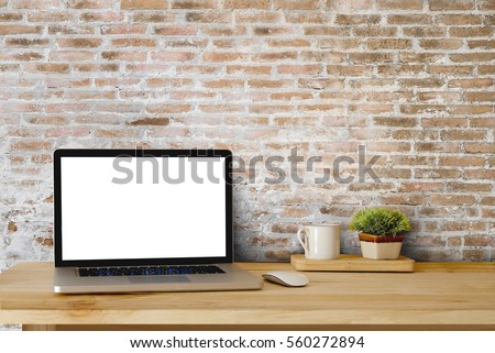 Mock up of blank laptop on the desk. Personal laptop computer on wood table over brick wall background.