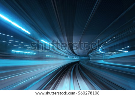 Motion blur of train moving inside tunnel Royalty-Free Stock Photo #560278108