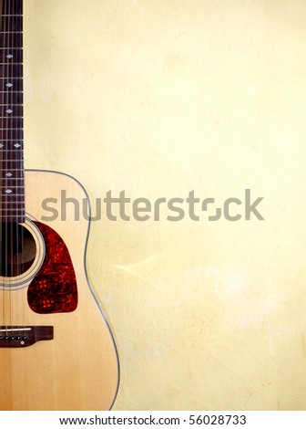 Color photo of an acoustic guitar near wall Royalty-Free Stock Photo #56028733