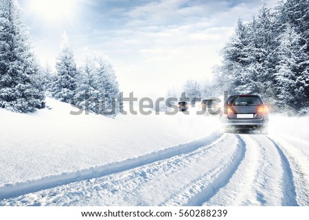 fast car on winter road and snow splash  Royalty-Free Stock Photo #560288239