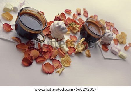 Day of valentina.Tasty dessert. Morning coffee with rose petals. Cakes, coffee, rose petals on white background, space for text heart made of rose petals