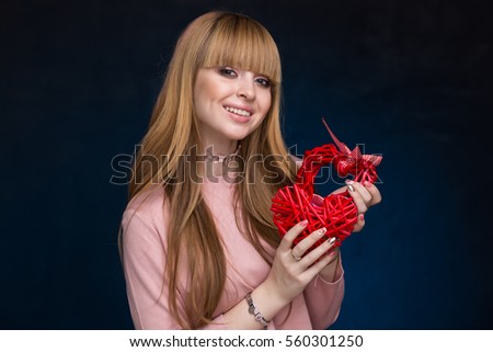 the girl in black and blue textured background with the straw red heart
