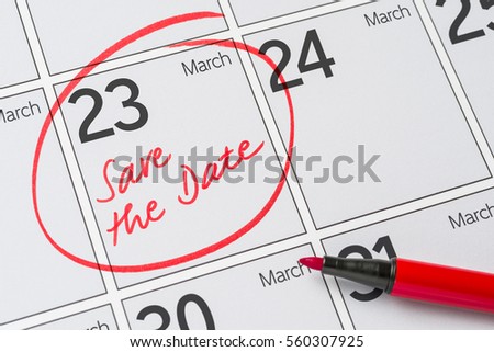 Save the Date written on a calendar - March 23 Royalty-Free Stock Photo #560307925
