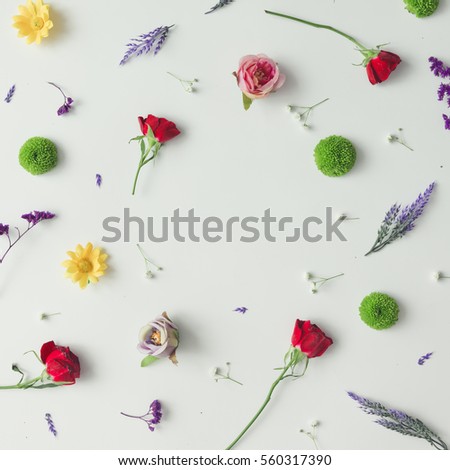 Creative pattern made of various flowers and leaves. Flat lay. Spring concept.