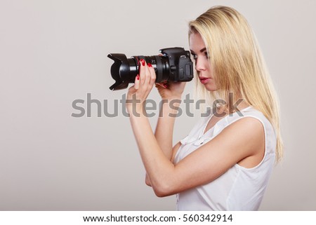Photographer girl shooting images. Attractive blonde woman face profile taking photo with camera.
