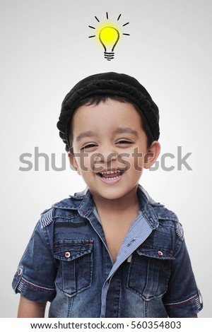 Portrait. happy little south asian boy wearing cultural hat. smiling and looking in the camera isolated on white