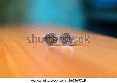 coins on wood table in blur background select focus on coins.