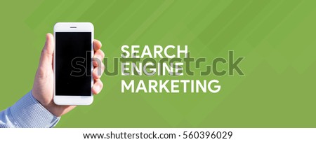 Smart phone in hand front of green background and written SEARCH ENGINE MARKETING