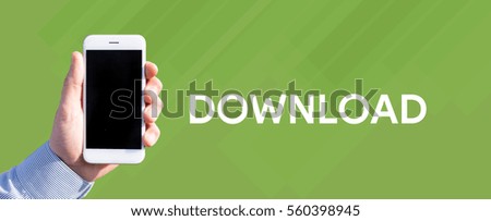 Smart phone in hand front of green background and written DOWNLOAD
