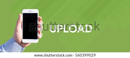 Smart phone in hand front of green background and written UPLOAD