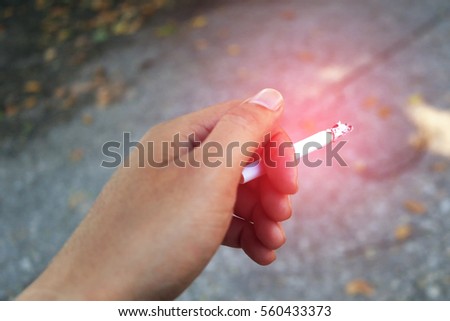 Hand holding cigarette unhealthy lifestyle