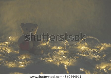 Cute teddy bear on wool Background with bokeh .Soft focus,low light.(selective focus). 