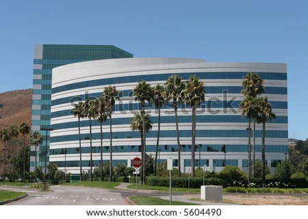 Curved office building with palm trees near San Francisco Airport