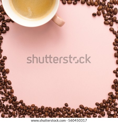 Cute frame made of coffee beans and a cup on a pink background mock up. Flat lay top view photo mockup.
