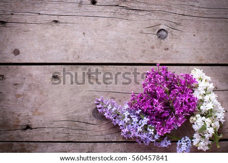 Spring background. Fresh aromatic lilac flowers on vintage wooden planks. Selective focus. Place for text. Floral still life.
