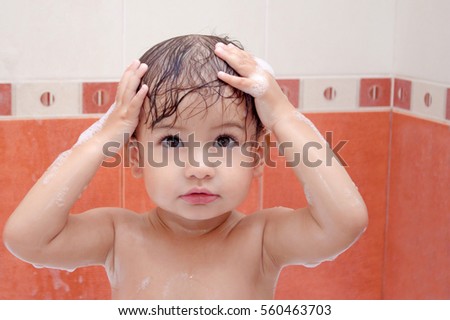 cute baby is swimming in bath