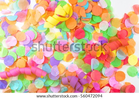 Close-up of colorful confetti and streamers with white background as template for birthday celebration or carnival