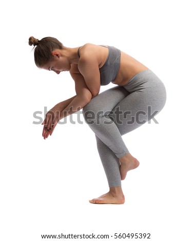 Woman practicing yoga in a studio isolated on a white background.