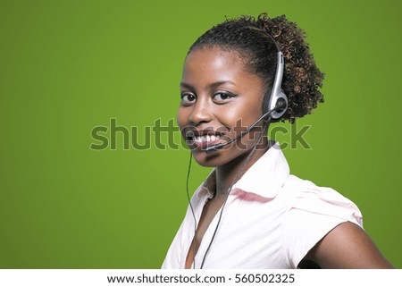 Portrait of a beautiful african secretary with handset. Online