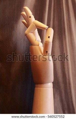 Wooden hand making the OK sign with a vintage background
