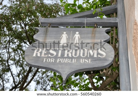 Wooden restrooms sign