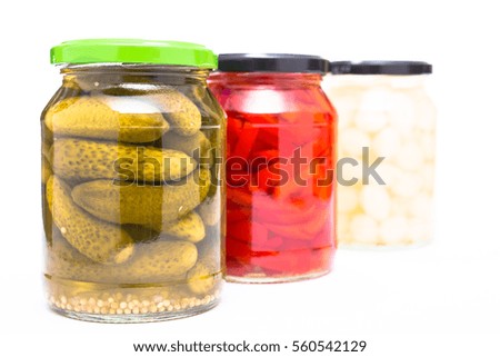 Cornichons, paprika and onions in glass pickled whie isolated