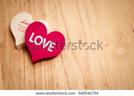 white and red couple hearts with word LOVE on wooden texture background. symbol of love and valentines day. can be use to greeting card and background for special event.