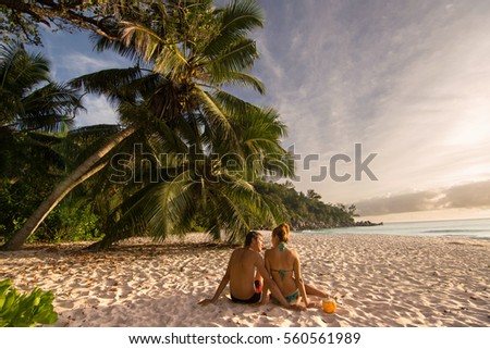Couple in love relaxing on exotic beach from Anse Georgette Praslin , Seychelles / Couple in perfect honeymoon destination