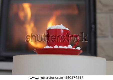 Red cup with marshmallows on fireplace background. cozy red cup. Valentines red cup