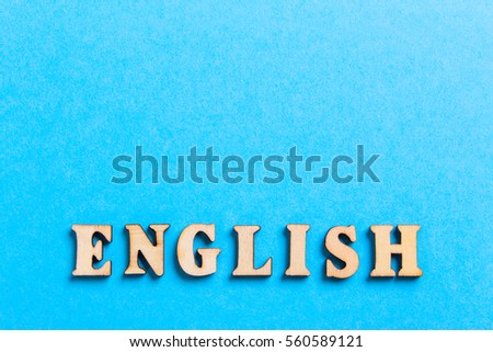 The word of English of wooden letters of the alphabet on a blue background