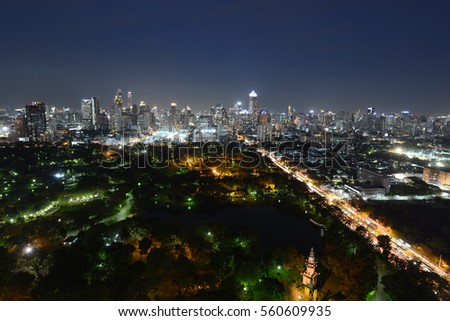 a view over the big asian city of Bangkok , Thailand at nighttime when the tall skyscrapers are illuminated

