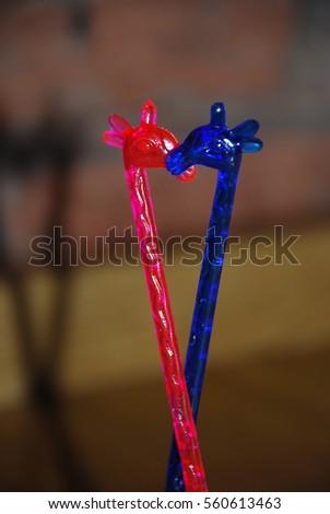 Little toy colorful plastic and kissing giraffes