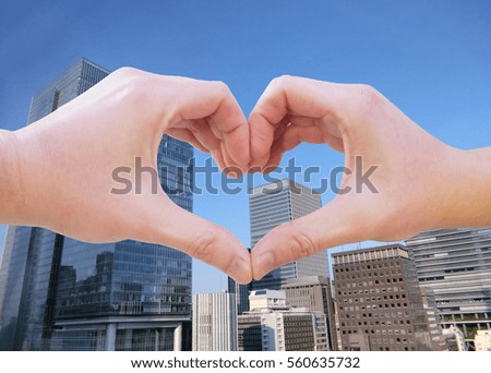 hand sign heart city background