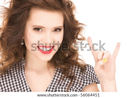 picture of happy teenage girl showing devil horns gesture
