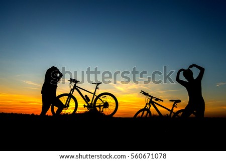 Family cyclist and Bicycle silhouettes on sunsets