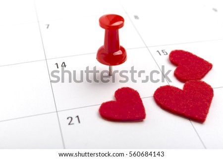 Concept image of a Calendar with a red push pin. Closeup shot of a thumbtack attached. The words heart shape written on a white notebook to remind you an important appointment.