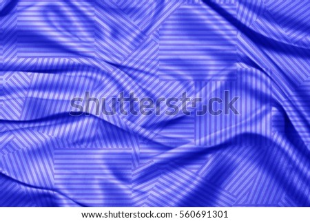 Silk fabric with an abstract blue geometric patterns and soft folds