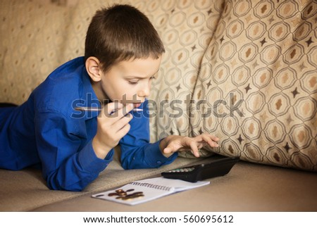 the boy is studying Finance Royalty-Free Stock Photo #560695612