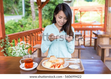 Woman taking photo on her breakfast