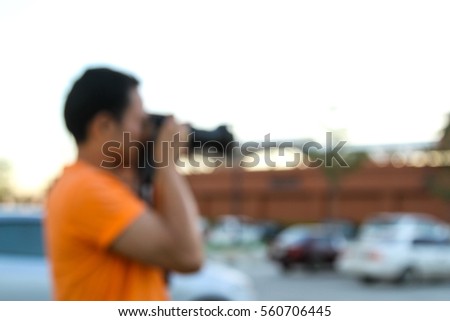 Blurred a man taking photo