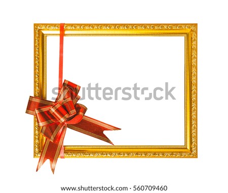 Golden frame with red silky bow isolated on white