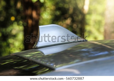 GPS antenna shark fin shape on a roof of car for radio navigation system, outdoor car radio antenna