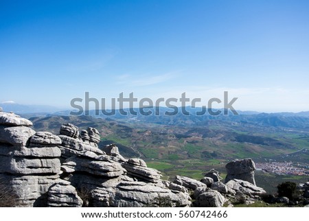 A view to mountains and villages from observation deck at natural park El Torcal in Spain.