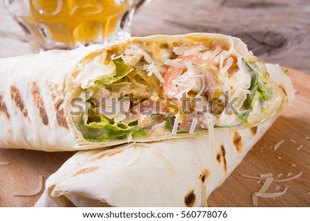 Fresh burrito rolls served on wooden board
