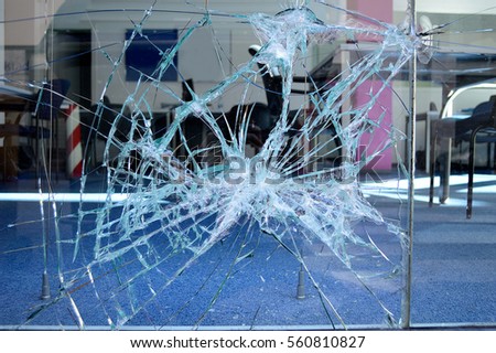close up of broken office window glass Royalty-Free Stock Photo #560810827